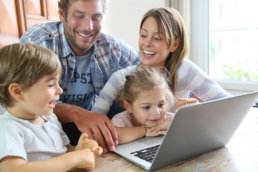 Blog - Happy Family With Kids Using Laptop At Home