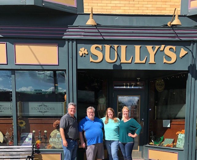Blog - Business Spotlight - Sully’s Irish Pub - Sully's Restaurant Front and Workers Standing Outsdie the Front Doorjpg